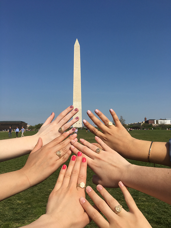 Belles display their rings against backdrop of the Washington Monument