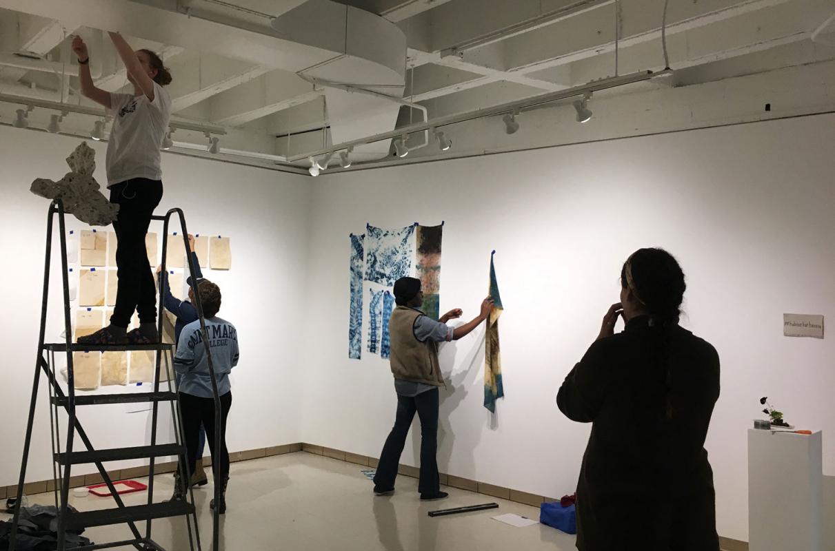 Students in Sustainable Textiles course install their work in the art gallery