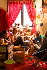 students laughing in a dorm room